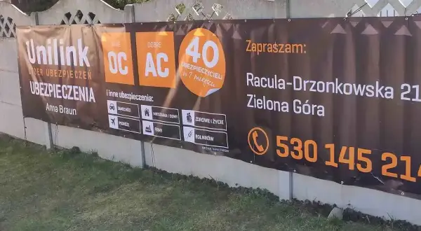 Baner reklamowy Unilink z informacją o ubezpieczeniach OC/AC, adres i telefon kontaktowy.