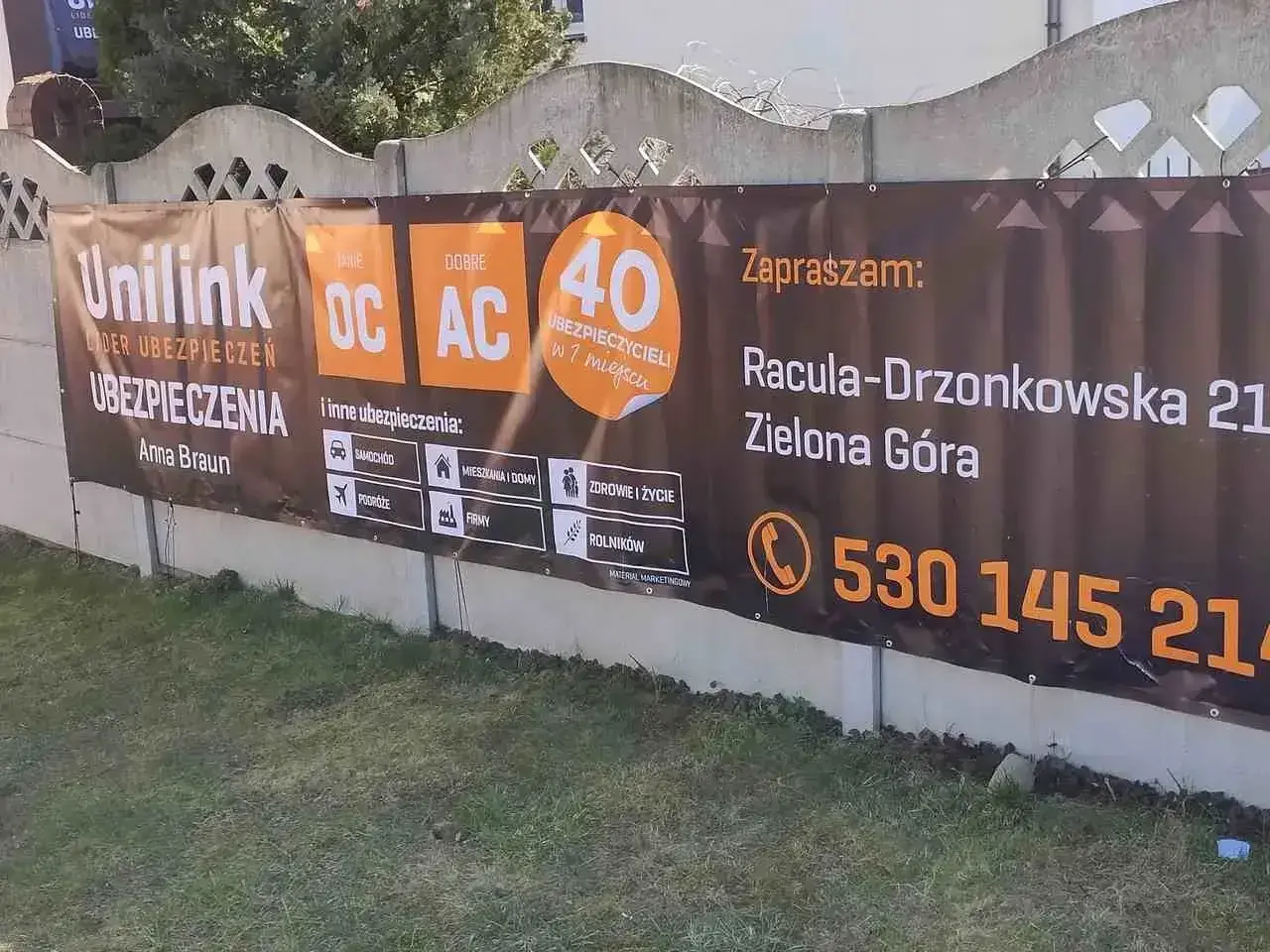 Baner reklamowy Unilink z informacją o ubezpieczeniach OC/AC, adres i telefon kontaktowy.
