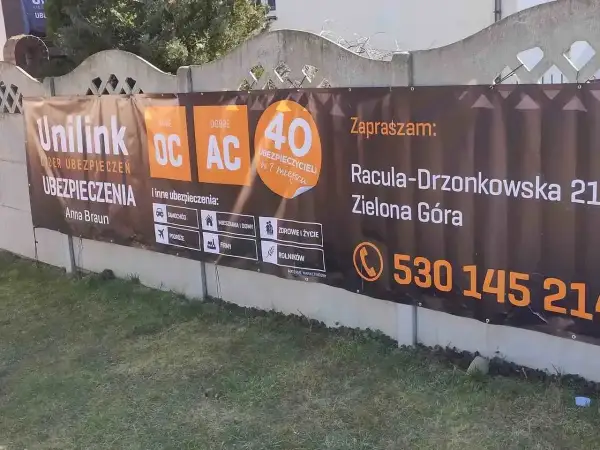 Baner reklamowy Unilink z informacją o ubezpieczeniach OC/AC, adres i telefon kontaktowy.